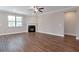 Spacious living room features a fireplace, recessed lighting, a ceiling fan, hardwood flooring, and large windows at 2628 Songbird Ln, Grayson, GA 30017