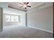 Spacious main bedroom with trey ceilings, fan, and large windows for natural light at 2628 Songbird Ln, Grayson, GA 30017