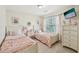 Charming bedroom featuring two twin beds with pink linens, complemented by a neutral color palette at 2845 Hickory Cir, Snellville, GA 30078