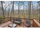 Enjoy the outdoors on this inviting deck with seating, offering serene views of the surrounding trees at 2845 Hickory Cir, Snellville, GA 30078