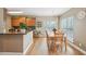 Open concept with a wood dining table complemented by hardwood flooring and lots of natural light at 2845 Hickory Cir, Snellville, GA 30078