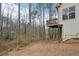 Backyard view of the home featuring an outdoor deck and serene views of the surrounding trees at 2845 Hickory Cir, Snellville, GA 30078