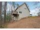 Exterior view of the home featuring an outdoor deck and serene views of the surrounding trees at 2845 Hickory Cir, Snellville, GA 30078