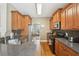Well-lit kitchen area with wooden cabinetry, tiled backsplash, and stainless steel appliances, ready for culinary adventures at 2845 Hickory Cir, Snellville, GA 30078