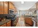 Cozy kitchen boasting wood cabinets, tile backsplash, and modern stainless steel appliances at 2845 Hickory Cir, Snellville, GA 30078