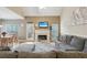 Spacious living room open to dining area, featuring a fireplace, comfortable seating, and plenty of natural light at 2845 Hickory Cir, Snellville, GA 30078