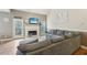 Comfortable living room featuring a cozy fireplace, plush gray sectional, and hardwood floors, perfect for relaxation at 2845 Hickory Cir, Snellville, GA 30078