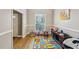 Bright playroom featuring hardwood floors, neutral paint, and a large window for ample natural light, perfect for activities at 2845 Hickory Cir, Snellville, GA 30078