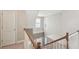 Bright open staircase leading to the home's entry, featuring white railings and natural light from the window above at 2845 Hickory Cir, Snellville, GA 30078
