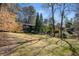 Expansive backyard showcasing the home's setting among mature trees and natural landscape, offering privacy at 3240 Pinestream Nw Rd, Atlanta, GA 30327
