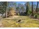 Large backyard featuring a spacious lawn, mature trees, and lush surroundings, providing a private outdoor space at 3240 Pinestream Nw Rd, Atlanta, GA 30327