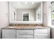 Well-lit bathroom features a double vanity with granite countertops and a large mirror at 3240 Pinestream Nw Rd, Atlanta, GA 30327