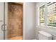 Bathroom features tiled shower with glass door and a window with white shutter at 3240 Pinestream Nw Rd, Atlanta, GA 30327