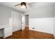 Bedroom features hardwood floors, a ceiling fan, and a built-in desk with drawers at 3240 Pinestream Nw Rd, Atlanta, GA 30327