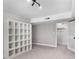 Bedroom with a window, neutral carpet, and a large white shelving unit at 3240 Pinestream Nw Rd, Atlanta, GA 30327