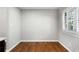 Bright dining area features hardwood floors and natural light from the window with shutters at 3240 Pinestream Nw Rd, Atlanta, GA 30327