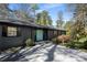 Close-up of home with a slate gray exterior, a turquoise door, and manicured front yard at 3240 Pinestream Nw Rd, Atlanta, GA 30327