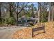 View of house from street with sign: 3240 Pinestream Rd at 3240 Pinestream Nw Rd, Atlanta, GA 30327