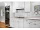 The kitchen features stainless steel appliances, white cabinets, and subway tile backsplash at 3240 Pinestream Nw Rd, Atlanta, GA 30327