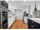 Bright kitchen featuring stainless appliances, custom cabinetry, an island, and hardwood floors at 3240 Pinestream Nw Rd, Atlanta, GA 30327