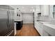 Bright kitchen features stainless steel appliances, a large island, and white cabinetry at 3240 Pinestream Nw Rd, Atlanta, GA 30327