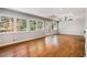 Bright living room with hardwood floors, large windows, and glass doors to the backyard at 3240 Pinestream Nw Rd, Atlanta, GA 30327