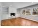 Cozy living room with built-in bookshelves and a fireplace, offering a comfortable space at 3240 Pinestream Nw Rd, Atlanta, GA 30327