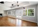 Spacious living room with hardwood floors, natural light, and access to the outdoor deck at 3240 Pinestream Nw Rd, Atlanta, GA 30327