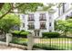 Elegant white building with manicured lawn and black iron fence exudes curb appeal at 1072 Piedmont Ne Ave # 108, Atlanta, GA 30309