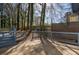 Enjoy the outdoors on this back deck with a modern horizontal railing and a view of the wooded yard at 40 Cumberland Dr, Rex, GA 30273
