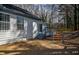 Backyard of home features stairs leading to a fenced backyard with mature trees at 40 Cumberland Dr, Rex, GA 30273