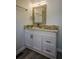 Modern bathroom featuring a granite vanity with framed mirror and modern faucet at 40 Cumberland Dr, Rex, GA 30273