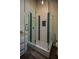 Modern glass shower with custom tile work and granite vanity in the bathroom at 40 Cumberland Dr, Rex, GA 30273