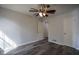 Cozy bedroom featuring hardwood floors, a ceiling fan, and two entry doors at 40 Cumberland Dr, Rex, GA 30273