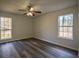 Spacious bedroom with hardwood floors, neutral walls, and natural light from two windows at 40 Cumberland Dr, Rex, GA 30273