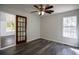 Bright bedroom featuring hardwood floors, ceiling fan and natural light from the window at 40 Cumberland Dr, Rex, GA 30273