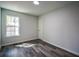 Neat bedroom with gray walls, hardwood floors, window and baseboard trim at 40 Cumberland Dr, Rex, GA 30273