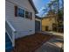 Side view showcasing the driveway and siding details at 40 Cumberland Dr, Rex, GA 30273