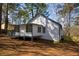Exterior view of home with a partially screened porch and stairway to the backyard at 40 Cumberland Dr, Rex, GA 30273