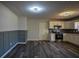 Living room featuring modern wainscoting and view of a kitchen at 40 Cumberland Dr, Rex, GA 30273