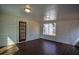 Bright sunroom featuring hardwood floors, windows, and a paneled door at 40 Cumberland Dr, Rex, GA 30273