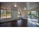 Bright sunroom with hardwood floors, multiple windows, and a sliding glass door at 40 Cumberland Dr, Rex, GA 30273