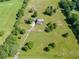 Aerial view showcasing a home with a large yard, mature trees and driveway to a detached garage at 4840 Pisgah Rd, Cumming, GA 30028