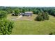Aerial view showcasing a home with a large yard, mature trees and driveway to a detached garage at 4840 Pisgah Rd, Cumming, GA 30028