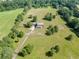 Aerial view showcasing a home with a large yard, mature trees and driveway to a detached garage at 4840 Pisgah Rd, Cumming, GA 30028
