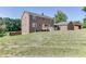 Brick home exterior with deck, set on a grassy lot with mature trees at 4840 Pisgah Rd, Cumming, GA 30028