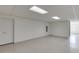 This basement features a large open space with tiled floor and drop ceiling and storage shelves at 4840 Pisgah Rd, Cumming, GA 30028