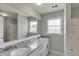 This bathroom features a double sink vanity with granite counters and a large mirror at 4840 Pisgah Rd, Cumming, GA 30028