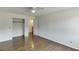 This bedroom features hardwood floors, ceiling fan and access to a closet and other rooms at 4840 Pisgah Rd, Cumming, GA 30028