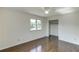 Bright bedroom featuring a ceiling fan, hardwood floors, and a closet for storage at 4840 Pisgah Rd, Cumming, GA 30028